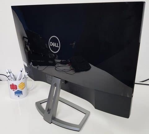 Een Dell S2318H-monitor staat op een bureau naast een kopje koffie.