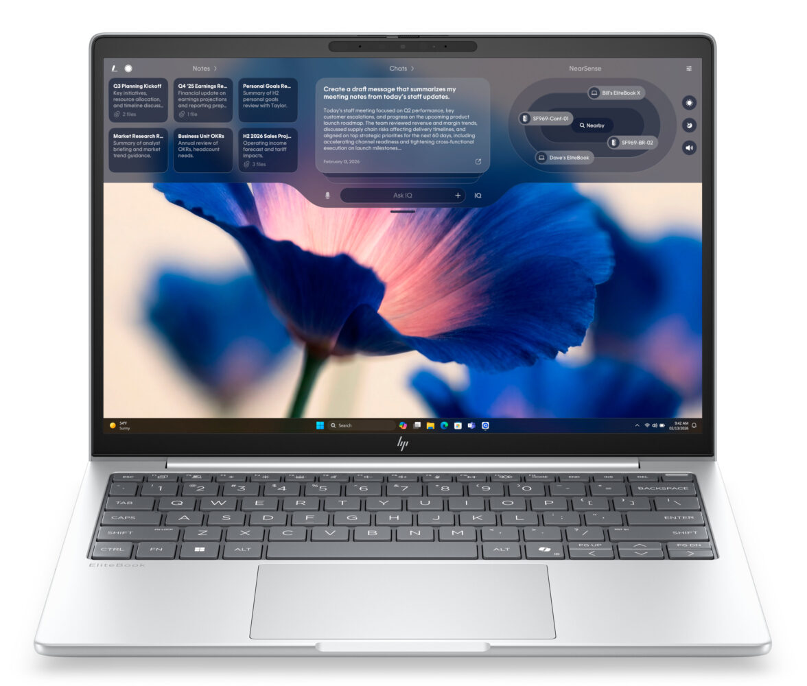 Een zilverkleurige HP laptop toont een desktopscherm met een blauwe bloemenachtergrond en verschillende open notitie- en organisatie-apps.